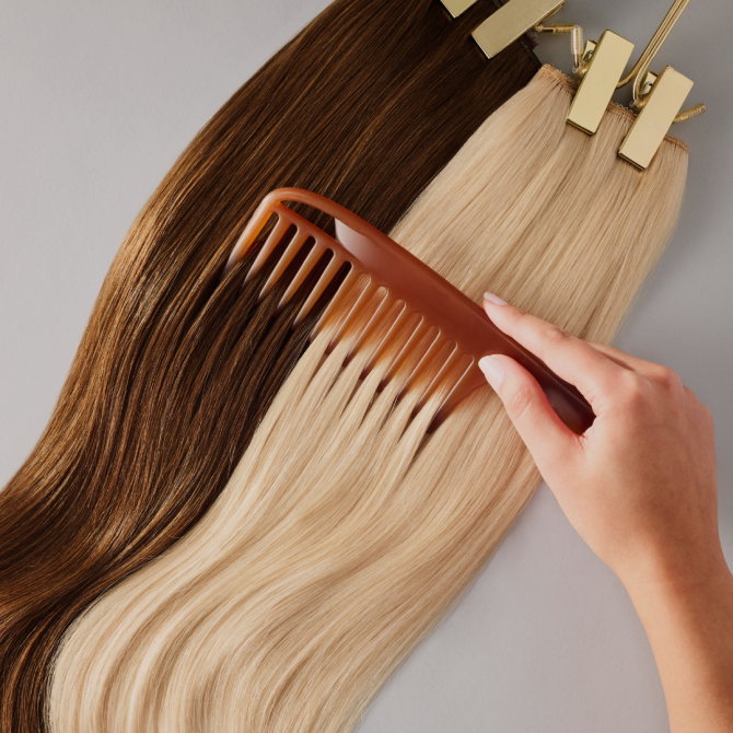 A woman carefully combing her hair extensions with a comb, ensuring smooth and tangle-free locks.